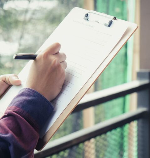 Certified building inspector reviewing property plans during a pre-purchase inspection in Proserpine, Queensland.