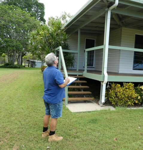 Building inspector conducting a thorough property inspection in Airlie Beach, QLD.