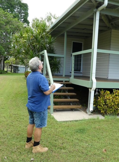 Certified inspector conducting a pre-purchase building inspection in the Whitsundays, Queensland.